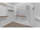 This well-organized walk-in closet has shelves and wooden poles for plenty of storage at 4301 E Abraham Ln, Phoenix, AZ 85050