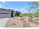 Inviting exterior with desert landscaping, a two-car garage, and a decorative rock stream at 4301 E Abraham Ln, Phoenix, AZ 85050