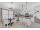 Bright kitchen featuring white cabinets, stainless steel appliances, a center island, and a cozy breakfast nook at 4301 E Abraham Ln, Phoenix, AZ 85050