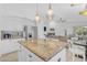 Open kitchen with a granite island, stainless steel appliances, and views into the adjacent living room at 4301 E Abraham Ln, Phoenix, AZ 85050