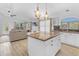 Spacious open-concept kitchen with an island and barstool seating, flowing into the living room at 4301 E Abraham Ln, Phoenix, AZ 85050