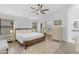 Serene main bedroom with a ceiling fan, ensuite bathroom, walk-in closet, and ample natural light at 4301 E Abraham Ln, Phoenix, AZ 85050