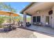 Inviting outdoor patio area with built-in grill, seating, lush green lawn, and ceiling fan at 4301 E Abraham Ln, Phoenix, AZ 85050
