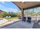 Inviting outdoor patio area with built-in grill, seating, lush green lawn, and views at 4301 E Abraham Ln, Phoenix, AZ 85050