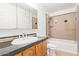 Bathroom featuring a single sink vanity with a bathtub and shower combo with tile surround at 4629 S Mill Ave, Tempe, AZ 85282