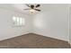 Bedroom featuring plush carpet, ceiling fan, and a window at 4629 S Mill Ave, Tempe, AZ 85282