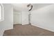 Bright bedroom featuring plush carpeting, white walls, closet, ceiling fan, and natural light at 4629 S Mill Ave, Tempe, AZ 85282