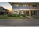 Charming townhome featuring a well-maintained front lawn, covered porch, and neutral brick facade at 4629 S Mill Ave, Tempe, AZ 85282