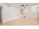 Bright living room with neutral tile flooring, white walls, staircase, and modern ceiling fan at 4629 S Mill Ave, Tempe, AZ 85282