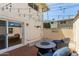 Private patio with stylish furniture, wood-look flooring, and string lights for outdoor enjoyment at 4629 S Mill Ave, Tempe, AZ 85282