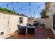 Back patio with brick pavers featuring patio furniture, grill, and string lights at 4629 S Mill Ave, Tempe, AZ 85282