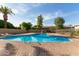 Community pool with brick pavers, surrounded by mature trees, with lounge chairs for relaxing poolside at 4629 S Mill Ave, Tempe, AZ 85282