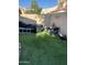 Enclosed backyard featuring artificial turf, a ladder, and covered patio furniture at 4743 W Alice Ave, Glendale, AZ 85302