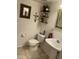 Bathroom featuring a toilet, sink, decorative mirrors and shelving at 4743 W Alice Ave, Glendale, AZ 85302