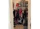 Walk-in closet filled with clothes, boxes, and storage containers at 4743 W Alice Ave, Glendale, AZ 85302