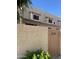 Tan two story with brown trim under the windows and the address displayed on the entry gate at 4743 W Alice Ave, Glendale, AZ 85302