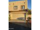 Two-car garage with a neutral door, framed windows above, and a landscaped yard at 4743 W Alice Ave, Glendale, AZ 85302