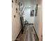 Hallway with art and decor on the walls and dark-stained baseboards at 4743 W Alice Ave, Glendale, AZ 85302