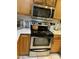 Kitchen with stainless steel oven, microwave and light wood cabinets at 4743 W Alice Ave, Glendale, AZ 85302