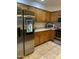 Stylish kitchen with wood cabinets, stainless steel appliances, and tiled flooring at 4743 W Alice Ave, Glendale, AZ 85302