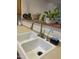 Kitchen sink with stainless steel faucet and various plants on the counter at 4743 W Alice Ave, Glendale, AZ 85302