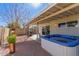 Backyard oasis with spa, covered patio, privacy wall, decorative stone, and desert landscaping, perfect for entertaining at 5210 W Jupiter N Way, Chandler, AZ 85226