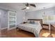 Bright bedroom featuring hardwood floors, with an ensuite bathroom behind a sliding barn door at 5210 W Jupiter N Way, Chandler, AZ 85226