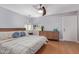 Bright bedroom featuring hardwood floors, a ceiling fan, and a large window at 5210 W Jupiter N Way, Chandler, AZ 85226