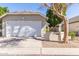 Attached two-car garage with a wide driveway and curb appeal, enhancing convenience at 5210 W Jupiter N Way, Chandler, AZ 85226