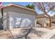 Attached two-car garage with a wide driveway with desert landscaping at 5210 W Jupiter N Way, Chandler, AZ 85226