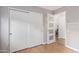 Hallway features white closet with sliding doors and a doorway with a clear glass door leading into another room at 5210 W Jupiter N Way, Chandler, AZ 85226