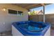 A close-up showcasing the inviting blue hot tub on the covered patio at 5210 W Jupiter N Way, Chandler, AZ 85226