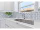Modern kitchen sink with white cabinets and quartz countertops at 5210 W Jupiter N Way, Chandler, AZ 85226