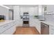 Modern kitchen with stainless steel appliances, white cabinets, and an island with seating at 5210 W Jupiter N Way, Chandler, AZ 85226