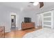 Comfortable main bedroom features light gray walls, wood floors, and ensuite bathroom, with sliding barn door at 5210 W Jupiter N Way, Chandler, AZ 85226
