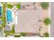 Overhead view of a backyard with a sparkling pool, hot tub, cozy patio, and desert landscaping at 5542 W Big Oak St, Phoenix, AZ 85083