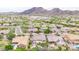 Scenic aerial view of a desert community with diverse homes, desert landscaping, and distant mountains at 5542 W Big Oak St, Phoenix, AZ 85083