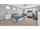 Well-lit bedroom with a home gym area, ceiling fan, and neutral colored carpet at 5542 W Big Oak St, Phoenix, AZ 85083