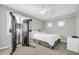 Carpeted bedroom featuring modern exercise equipment, a bed with white bedding, and natural lighting from dual windows at 5542 W Big Oak St, Phoenix, AZ 85083