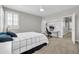Bedroom featuring a work area, ceiling fan, a bed, carpet floor, and natural lighting at 5542 W Big Oak St, Phoenix, AZ 85083