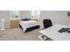 Bright bedroom with a modern bed, side tables, drawers, and a workstation with a comfortable chair at 5542 W Big Oak St, Phoenix, AZ 85083