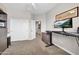 Bedroom featuring carpet floors, dual closets, and an adjacent workstation equipped with a modern monitor at 5542 W Big Oak St, Phoenix, AZ 85083