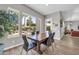 Dining area featuring a wooden table with seating, tiled floors, and views of the pool at 5542 W Big Oak St, Phoenix, AZ 85083