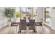 Dining area featuring a wooden table with seating, tiled floors, and views of the backyard at 5542 W Big Oak St, Phoenix, AZ 85083