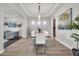 Elegant dining room with seating for ten, complemented by modern decor and wood-look tile flooring at 5542 W Big Oak St, Phoenix, AZ 85083