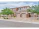 Beautiful stucco home featuring a three-car garage, manicured front yard, and stone veneer accents at 5542 W Big Oak St, Phoenix, AZ 85083