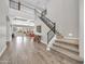 Grand foyer with soaring ceilings, staircase with iron railing, and wood-look tile flooring at 5542 W Big Oak St, Phoenix, AZ 85083