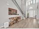 Elegant foyer featuring soaring ceilings, statement staircase, and stylish wood-look floors at 5542 W Big Oak St, Phoenix, AZ 85083