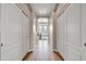 Hallway with wood floors and a bright view leads to a bathroom featuring a gray counter at 5542 W Big Oak St, Phoenix, AZ 85083