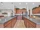 Updated kitchen featuring stone countertops, wood cabinetry, and stainless steel appliances at 5542 W Big Oak St, Phoenix, AZ 85083